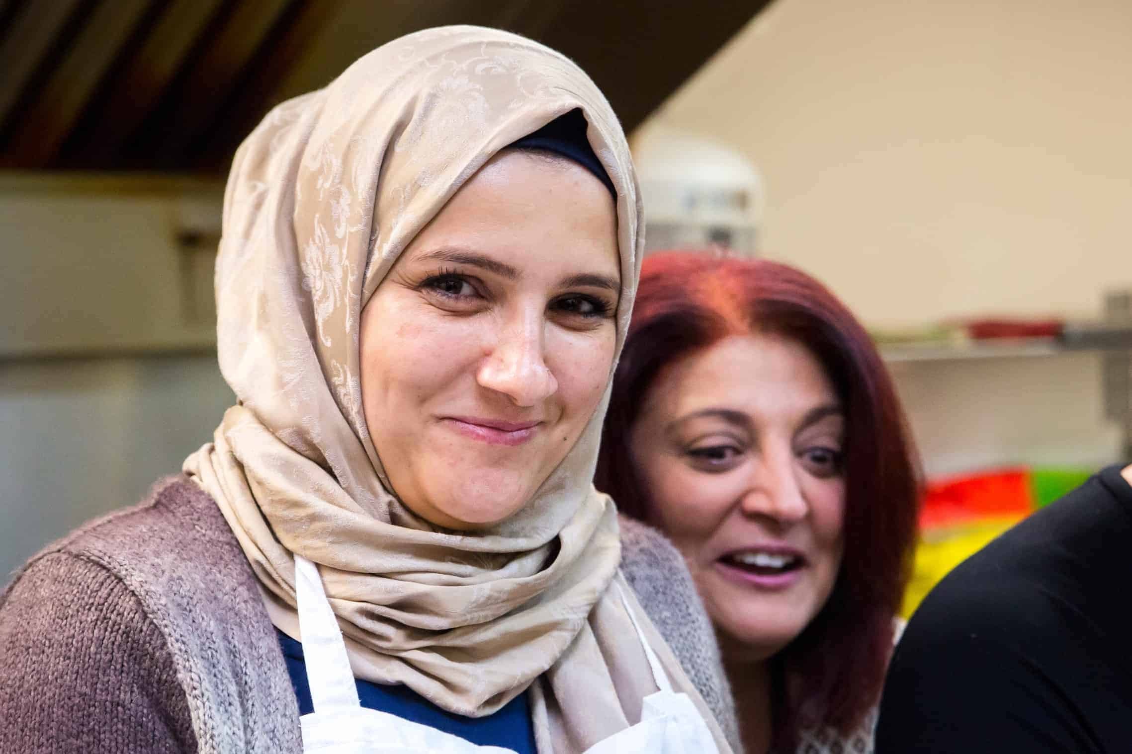 On the right, Sonia Habashy, community facilitator with EMCN, laughs with Tahany (left), who emigrated from Syria with her three children 11 months ago. Tahany’s husband died in the war and she lives with her sister and her children in Edmonton.| Rebecca Lippiatt