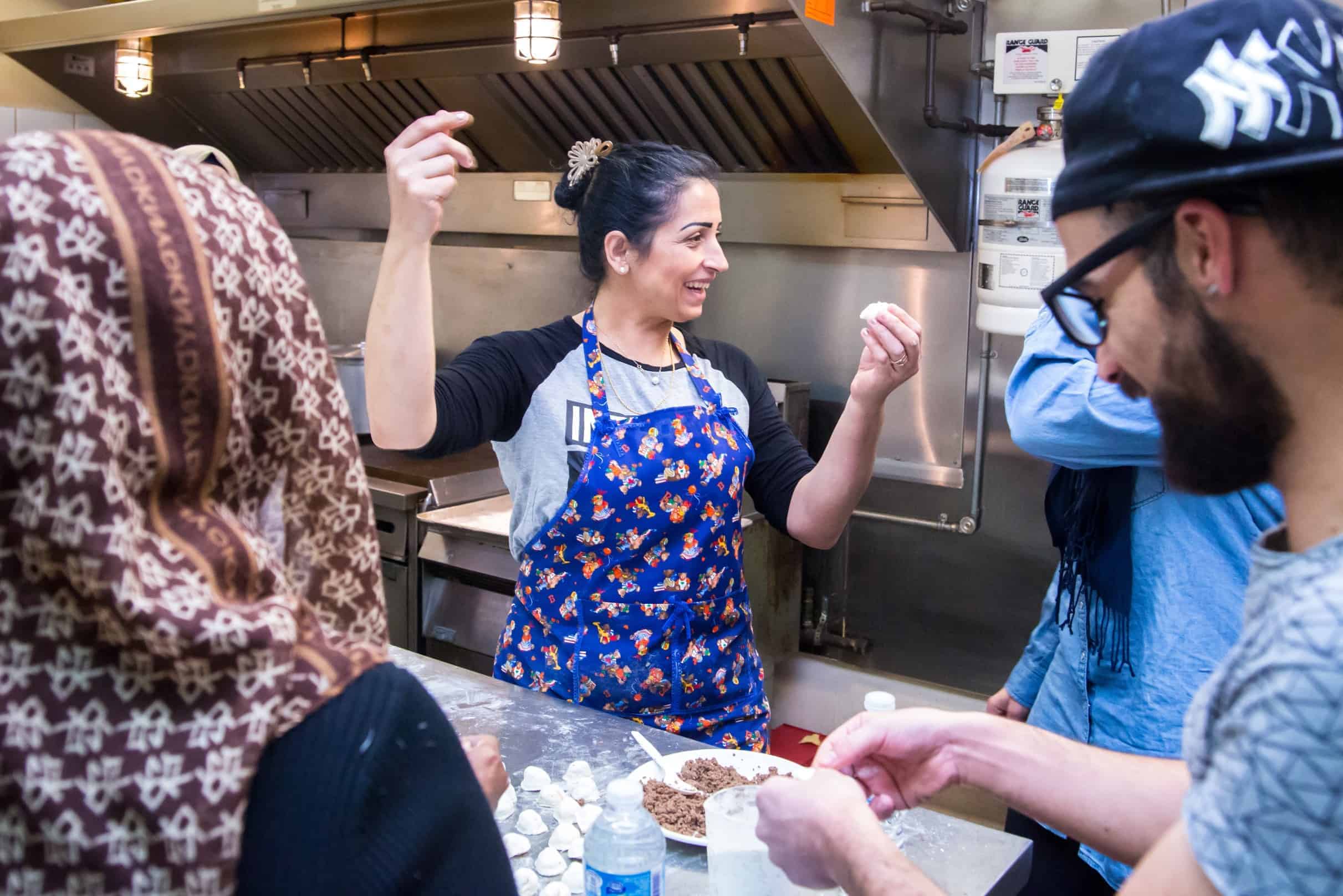 Lila, who immigrated from Syria 11 months ago, leads this week’s class. She breaks into a song and dance while she teaches the group to cook traditional Syrian food. Lila wants to open her own restaurant in Edmonton.| Rebecca Lippiatt
