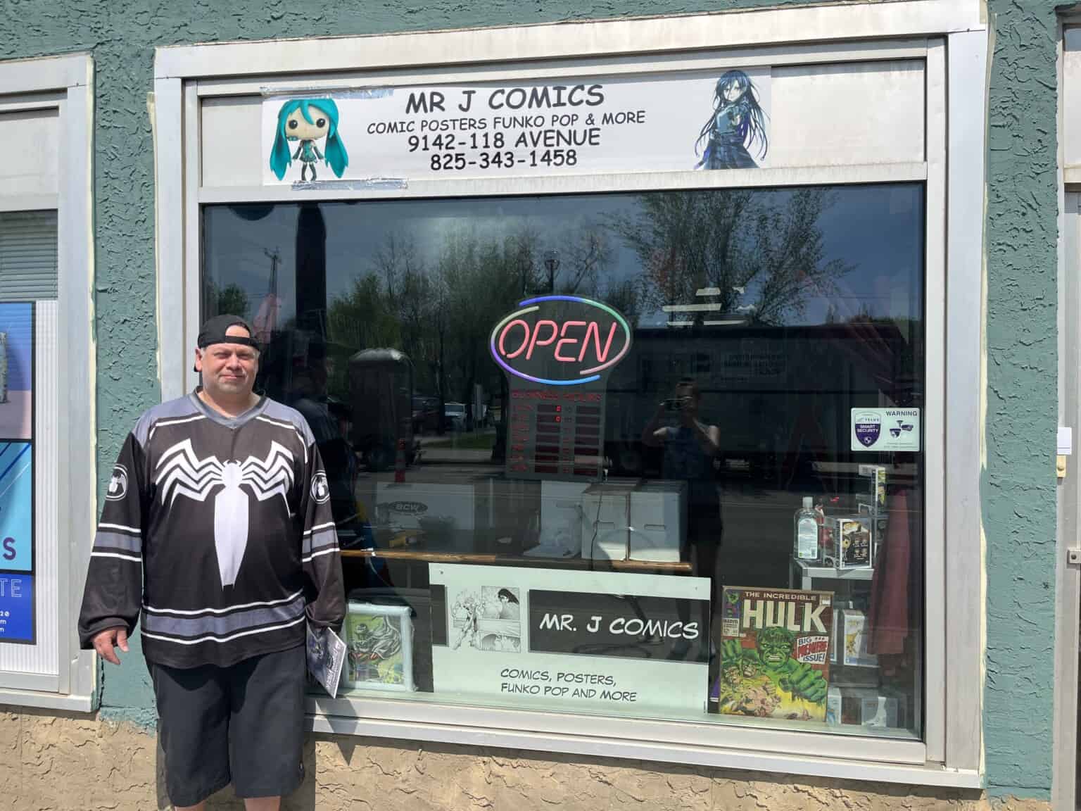 Joe Parent stands in front of his comic book shop,